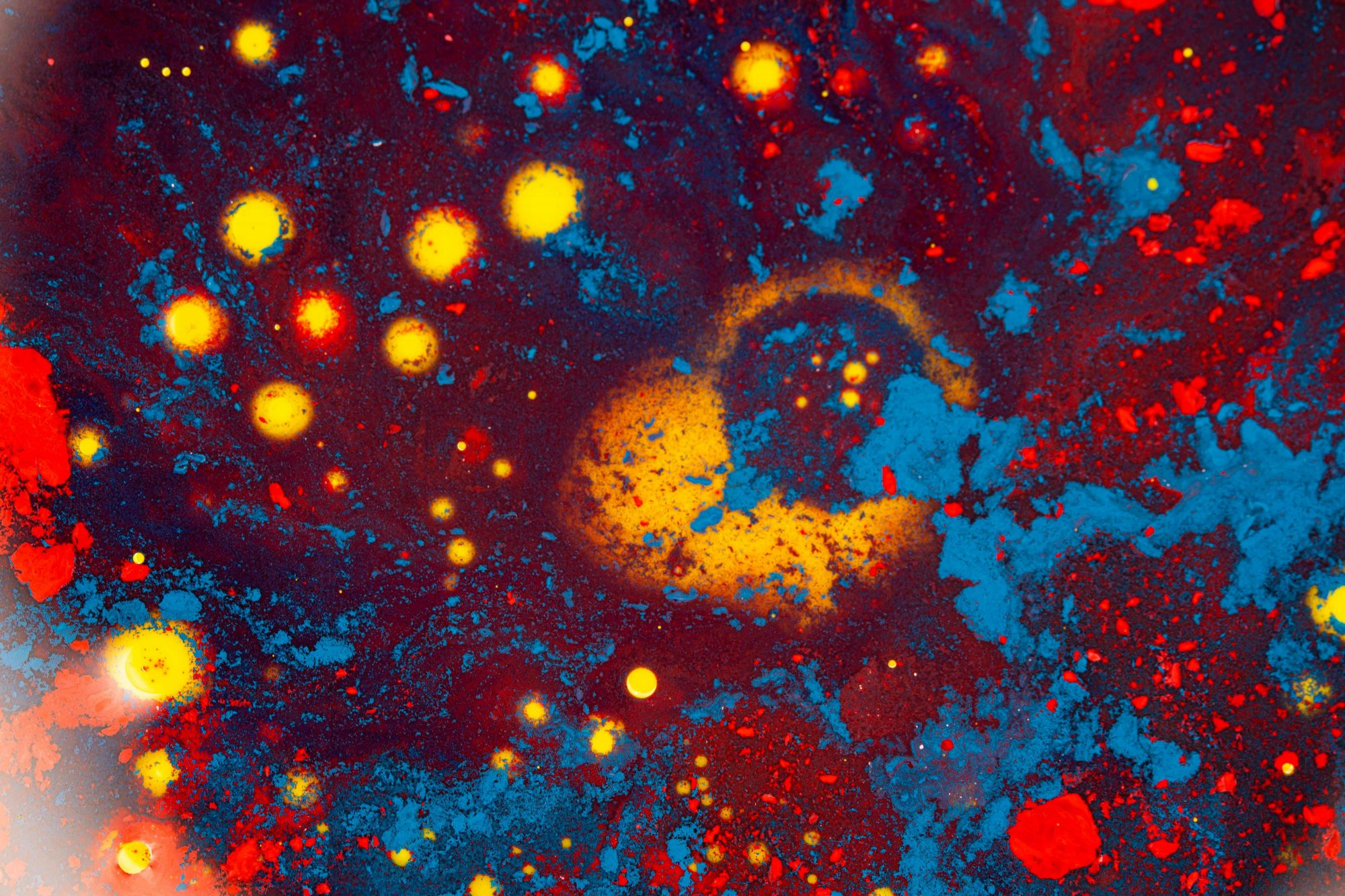 A vivid abstract pattern resembling a cosmic scene with colorful textures and patterns.